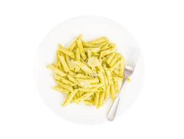 White plate with pasta and pesto photo