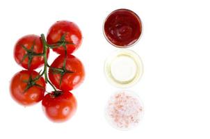 Ripe red tomatoes, ketchup, oil, salt. Photo