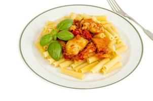 Pasta with pieces of chicken, tomatoes and sweet paprika. photo