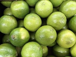 Macro photo green limes. Stock photo green lime citrus fruit background