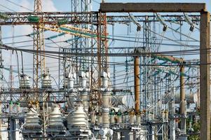 A fragment of an electrical substation with many wires and dielectric insulators. photo