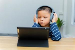 Children study online through tablets at home. photo