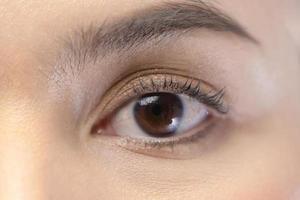 Close up brown woman eye . photo
