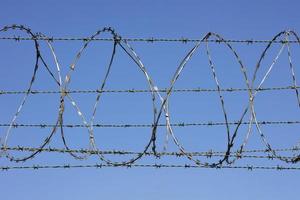 Barbed wire border fence and defense. photo