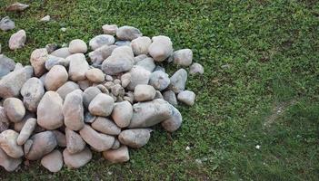 heap of stones on the grass photo