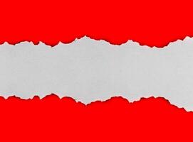 torn paper on red background with copy space for text photo
