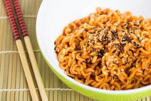 Instant noodles on wood background photo