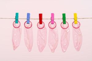 Unrolled latex condoms on white background photo