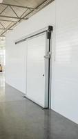 large freezer storage in the factory. closed door from warehouse photo