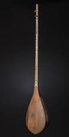 ancient Asian stringed musical instrument on black background with backlight photo