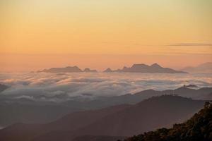 Foggy Mountain Dramatic Sunrise Background landscape Thailand photo