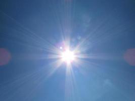 blue sky with white clouds and sun photo