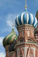 Detail of Saint Basil Cathedral. Towers with colorful domes. Blue sky. Red Square, Moscow photo