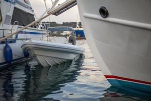 Small motorboat at the dock with beautiful reflections in the water. photo