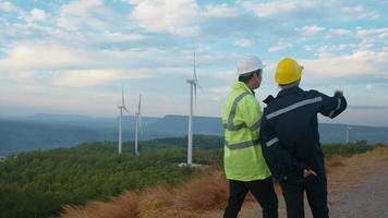 people engineer are wearing a protective helmet on head, using tablet Analytics engineering data. video