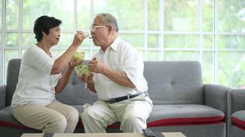 An elderly couple are eating healthy food , grandparents health care concept . video