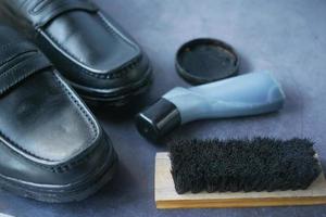 cleaning Shoe with a brush on floor photo