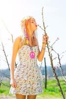 Girl kisses the blossoming of a flower in spring photo