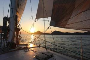 Sunset view over the deck of a sailboat photo