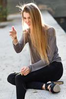 Happy blonde girl smiling in urban background photo