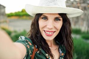 Hiker young woman taking a selfie photograph outdoors photo