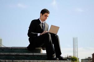 Businessman holding a laptop computer photo