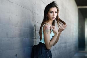 Beautiful young woman in urban background photo