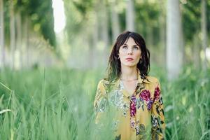 Woman enjoying the fresh air in green forest. photo