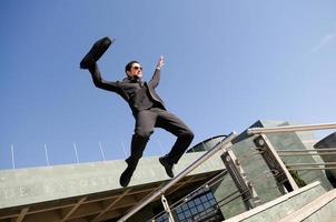 Businessman jumping in the street photo