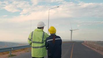 people engineer are wearing a protective helmet on head, using tablet Analytics engineering data. video