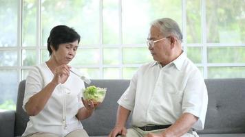 An elderly couple are eating healthy food , grandparents health care concept .