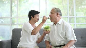 An elderly couple are eating healthy food , grandparents health care concept . video