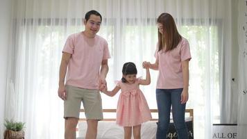 happy Asian family in white bedroom video