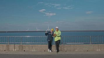 people engineer are wearing a protective helmet on head, using tablet Analytics engineering data. video