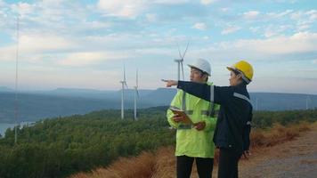 people engineer are wearing a protective helmet on head, using tablet Analytics engineering data. video