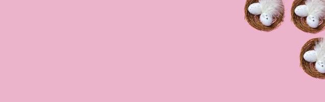 Easter eggs in a nest on a pink background. Closeup seamless pattern. Easter background concept, banner photo