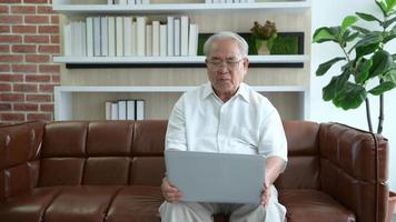 Senior Asian man making video call on social network with doctor consulting about health problems, head shot close up portrait.