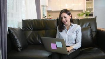 A young woman is using laptop to Video calling or Webcam to her family , telecommunications technology , parenthood family concept .
