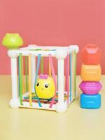 baby educational toy, a multi-colored cube. Development of fine motor skills and logical thinking. stacking pieces of a toy photo