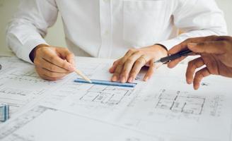 Team architect or engineering people discussion working on table together at a construction site. photo