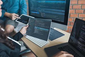 Two software developers are analyzing together about the code written into the program on the computer. photo