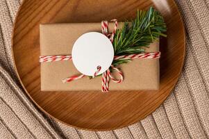 gift box on the wood plate and sweater with clear tag photo