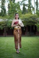 Beautiful Woman wearing typical Thai dress photo