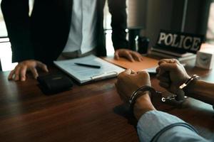 Police officers stand to make allegations about cyberbullying offenses at office room. photo