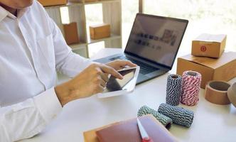 Teen business owners are using the tablet to browse the products that customers order. photo