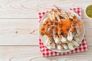 Steamed blue crab with spicy seafood sauce photo