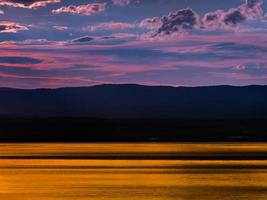 Gorgeous colors of the sunset over Lake Geneva, the reflection of the setting sun in the water, the atmosphere of peace and tranquility photo