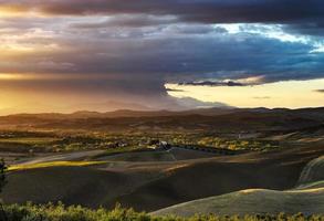 Villa in Italy, old farmhouse in the waves of tuscanian fields and hills photo