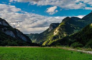 Panoramic view of alpine meadows and rocks in sunset evening lighting photo