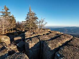 White snow and blue sky. Panoramic view of the silhouettes of the mountains. photo